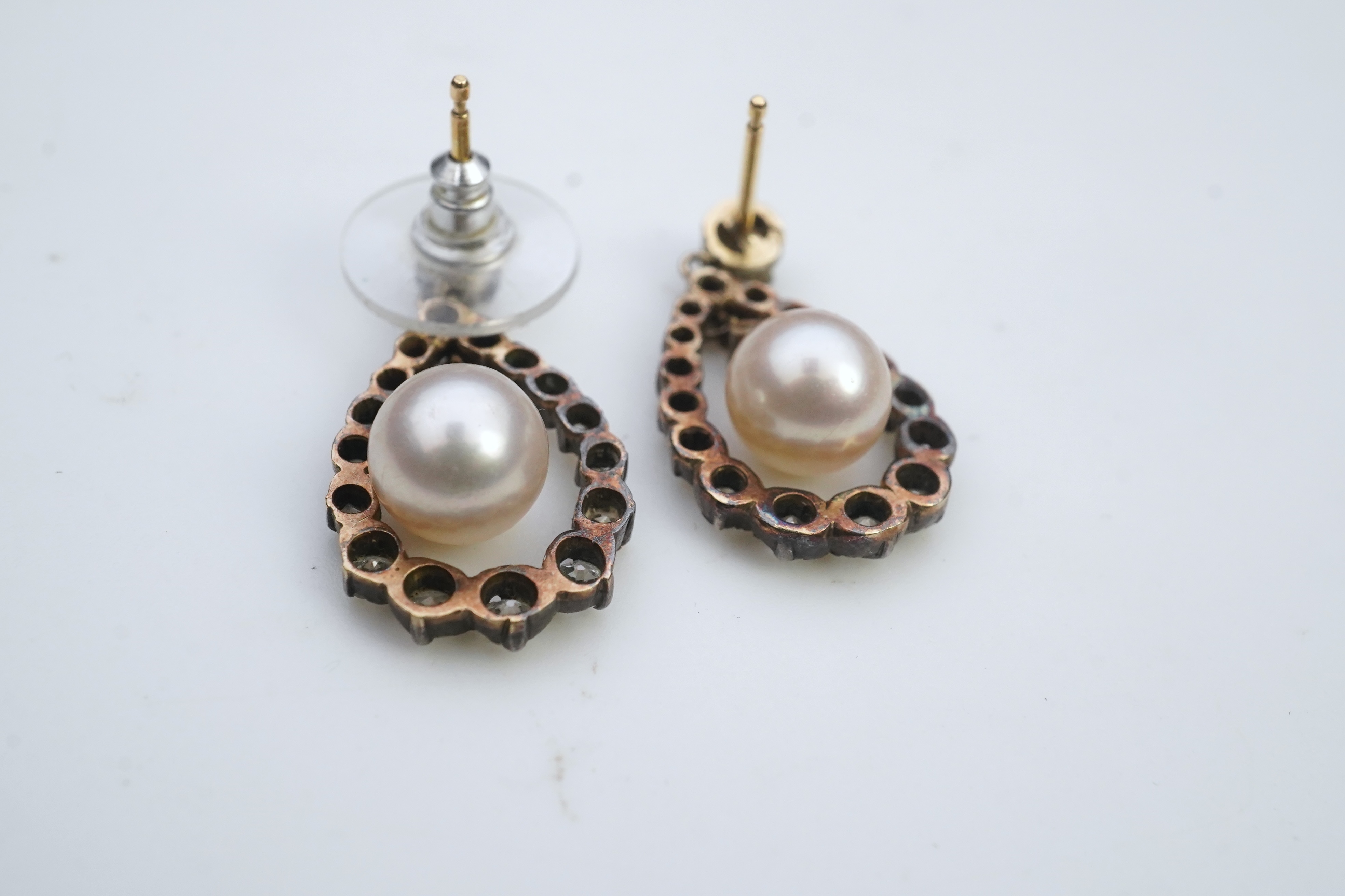 A pair of cultured pearl and diamond earrings